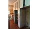 Vintage kitchen with white cabinetry, a vintage refrigerator, and hardwood floors at 208 E Main St, Cleveland, NC 27013