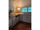 Classic kitchen showcasing white cabinets, wooden countertops, and appliances at 208 E Main St, Cleveland, NC 27013