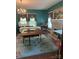 Living room with chandelier, fireplace, and large windows at 208 E Main St, Cleveland, NC 27013
