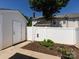 Private fenced backyard with storage shed and minimal landscaping features a small mulched garden area at 2147 Lake Breeze Ln, Denver, NC 28037