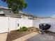 This fenced backyard includes a mulch garden, patio, and a grill, perfect for outdoor enjoyment at 2147 Lake Breeze Ln, Denver, NC 28037