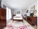 Bedroom features a four-poster bed, rug, wooden dresser, and a window at 2147 Lake Breeze Ln, Denver, NC 28037