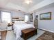 Bright bedroom featuring a ceiling fan, wood floors, a bed, and natural light at 2147 Lake Breeze Ln, Denver, NC 28037