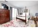 Bright bedroom with four-poster bed, rug, dresser, and natural light at 2147 Lake Breeze Ln, Denver, NC 28037