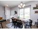 Bright dining room featuring modern chandelier, rustic wood table and large window for natural light at 2147 Lake Breeze Ln, Denver, NC 28037
