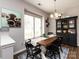 Stylish dining room with a window, hutch, rustic wood table, and elegant decor at 2147 Lake Breeze Ln, Denver, NC 28037