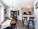 Cozy dining area with stylish hutch, bar stool seating, and open to the kitchen at 2147 Lake Breeze Ln, Denver, NC 28037