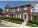 Attractive townhome featuring brick facade, blue shutters, landscaping, and covered entry to create a curb appeal at 2147 Lake Breeze Ln, Denver, NC 28037