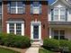 Inviting townhome with brick facade, blue shutters, and a well-maintained lawn and welcome front door at 2147 Lake Breeze Ln, Denver, NC 28037