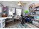 Bright home office with large windows, ceiling fan, desk, workout bike, and storage at 2147 Lake Breeze Ln, Denver, NC 28037