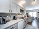 Charming kitchen featuring gray cabinets, modern appliances, hardwood floors, and adjacent dining area at 2147 Lake Breeze Ln, Denver, NC 28037