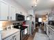 Modern kitchen with sleek appliances, white cabinets, and an open view to the living area at 2147 Lake Breeze Ln, Denver, NC 28037