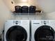 The laundry room features a modern washer and dryer set with shelving above at 2147 Lake Breeze Ln, Denver, NC 28037
