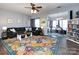 Bright living room with hardwood floors, ceiling fan, large sofa, colorful rug, and lots of light at 2147 Lake Breeze Ln, Denver, NC 28037