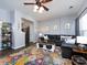 Well-lit living room featuring hardwood floors, a large sofa, a colorful rug, and gray walls at 2147 Lake Breeze Ln, Denver, NC 28037