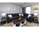 Living room featuring hardwood floors, gray walls, a ceiling fan, large sofa, and coffee table at 2147 Lake Breeze Ln, Denver, NC 28037