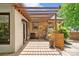Back patio with wooden pergola with stylish wooden planters, brick facade, and neutral paint at 232 Scottridge Dr, Charlotte, NC 28217