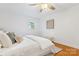 Comfortable bedroom featuring hardwood floors, a ceiling fan, and a bright window at 232 Scottridge Dr, Charlotte, NC 28217