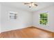 This bedroom has two windows, a ceiling fan, and beautiful hardwood floors at 232 Scottridge Dr, Charlotte, NC 28217