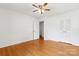 This bedroom features hardwood floors, a ceiling fan, and a closet for ample storage at 232 Scottridge Dr, Charlotte, NC 28217