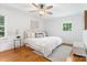 Cozy bedroom with hardwood floors, a ceiling fan, and a bright window at 232 Scottridge Dr, Charlotte, NC 28217
