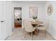 Dining area featuring a wood table, seating for four, wainscoting, and tile floors at 232 Scottridge Dr, Charlotte, NC 28217
