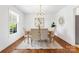 Elegant dining room with hardwood floors, modern chandelier, and ample natural light at 232 Scottridge Dr, Charlotte, NC 28217