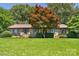 Charming brick home with lush green lawn and a mature Japanese maple tree at 232 Scottridge Dr, Charlotte, NC 28217