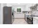 Well-equipped kitchen with white cabinets, stainless steel appliances, and tile flooring at 232 Scottridge Dr, Charlotte, NC 28217