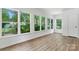 Bright sunroom with lots of windows and wood-look laminate floors at 232 Scottridge Dr, Charlotte, NC 28217