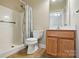 Bathroom with a shower, toilet, vanity with sink, and a neutral color palette at 2323 Granville Pl # A, Monroe, NC 28110