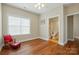 Cozy bedroom leading to an ensuite bathroom, featuring hardwood floors and a large window at 2323 Granville Pl # A, Monroe, NC 28110