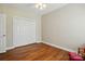 Well-lit bedroom features hardwood floors, a double closet, and neutral paint at 2323 Granville Pl # A, Monroe, NC 28110