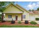Charming yellow home with inviting front porch, manicured landscaping, and attached garage at 2323 Granville Pl # A, Monroe, NC 28110