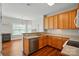 Functional kitchen featuring wood cabinets and a view into an eat-in area at 2323 Granville Pl # A, Monroe, NC 28110