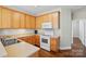Efficient kitchen with wood cabinets and essential appliances at 2323 Granville Pl # A, Monroe, NC 28110
