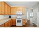 Well-lit kitchen features wooden cabinets, white appliances and hardwood floors at 2323 Granville Pl # A, Monroe, NC 28110