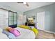 Bedroom features a ceiling fan, and a sliding barn door to the bathroom at 2485 Shanklin Ln, Denver, NC 28037
