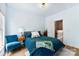 Bedroom features a blue chair, a modern light fixture and a blue quilted bedspread at 2485 Shanklin Ln, Denver, NC 28037