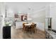 Dining area with wooden table and chairs, modern lighting, open to living room and kitchen at 2485 Shanklin Ln, Denver, NC 28037