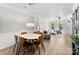Open dining area with wood floors, chic light fixture, and seamless flow to a bright living space at 2485 Shanklin Ln, Denver, NC 28037