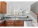 Open kitchen with stainless steel dishwasher and sink, wood cabinets, and view of the living area at 2485 Shanklin Ln, Denver, NC 28037
