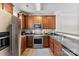 Well-equipped kitchen boasts stainless steel appliances, wood cabinets, and modern sink fixtures at 2485 Shanklin Ln, Denver, NC 28037