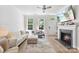 Comfortable living room featuring fireplace, natural light and an open floor plan at 2485 Shanklin Ln, Denver, NC 28037