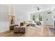 Bright and open living room with shiplap wall, light wood floors, and lots of natural light at 2485 Shanklin Ln, Denver, NC 28037