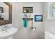 Charming powder room with a pedestal sink, decorative mirror, and rustic wall decor at 2485 Shanklin Ln, Denver, NC 28037