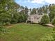 Expansive backyard with lush lawn, mature trees, and inviting outdoor space at 270 Kemp Rd, Mooresville, NC 28117