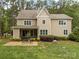 Serene backyard featuring patio, well-manicured lawn, and mature trees at 270 Kemp Rd, Mooresville, NC 28117