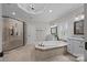 Bathroom featuring a soaking tub, walk-in shower, and dual vanities with granite countertops at 270 Kemp Rd, Mooresville, NC 28117