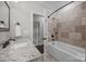 Stylish bathroom with tub, travertine tile surround, and granite countertop vanity at 270 Kemp Rd, Mooresville, NC 28117
